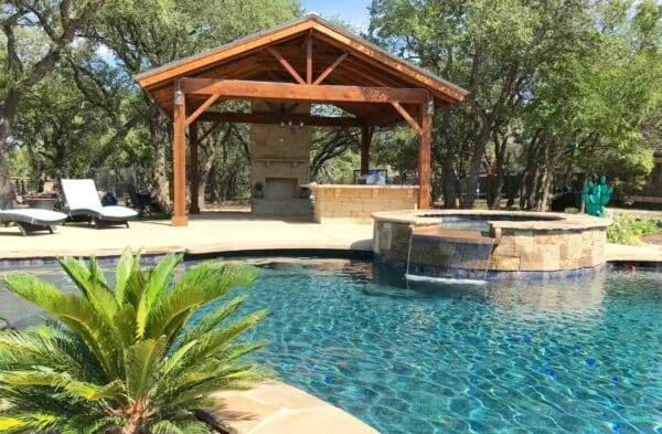 Covered patio and outdoor kitchen by Best of Texas Landscapes in Leander, Texas