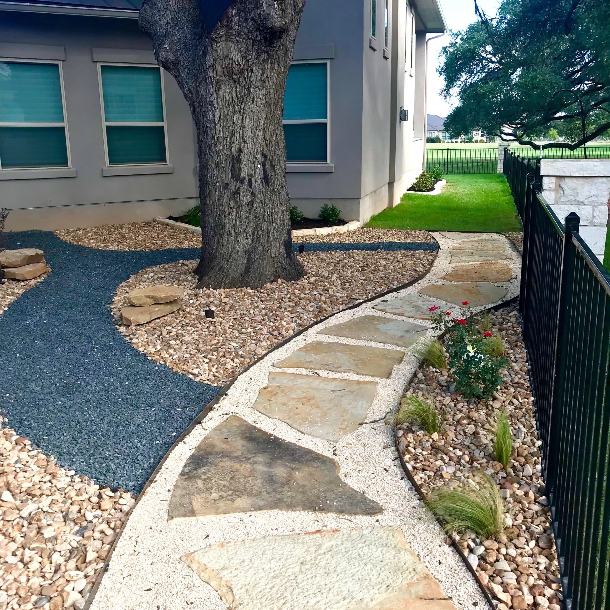 natural stone walkway with gravel and rock and plant accents