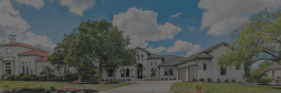 landscape design for front yard with white rock house by Best of Texas Landscapes