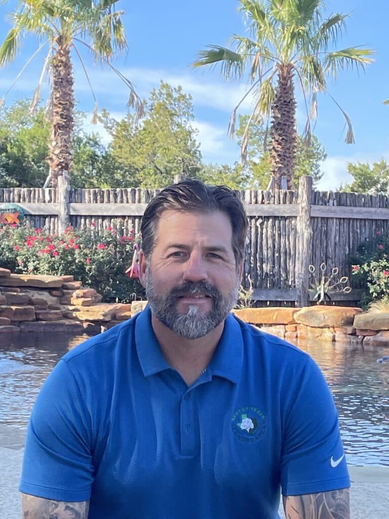 Jason Stubblefield sitting in front of pool and landscaping in Leander, Texas