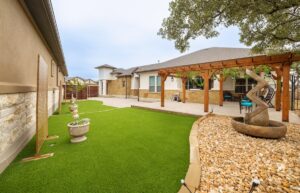 backyard landscape design with zen garden elements, pergola, and outdoor sculpture