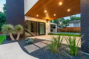 landscaping along breezeway of modern home with gray gravel rock and Texas-native plants by austin landscape designer