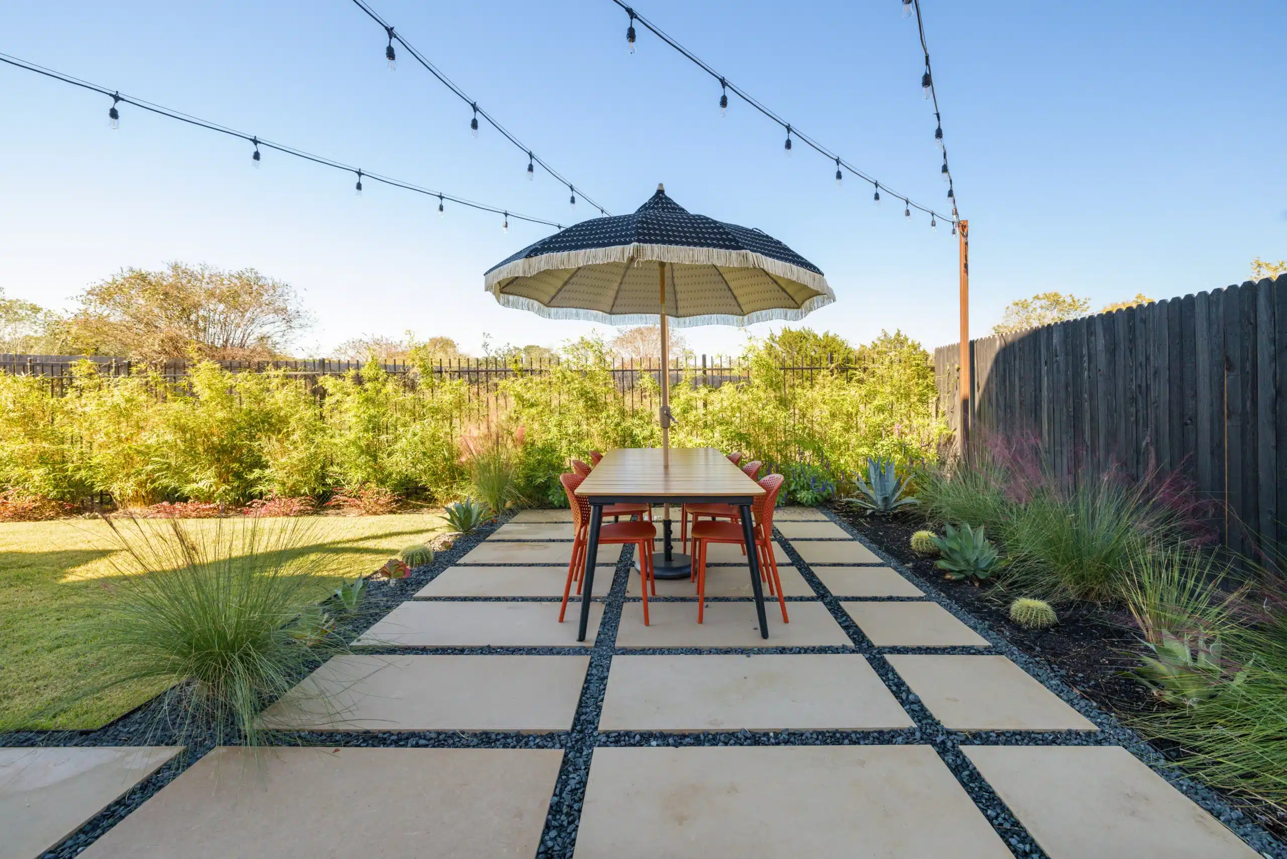 Backyard patio extensions for outdoor seating by Best of Texas Landscapes