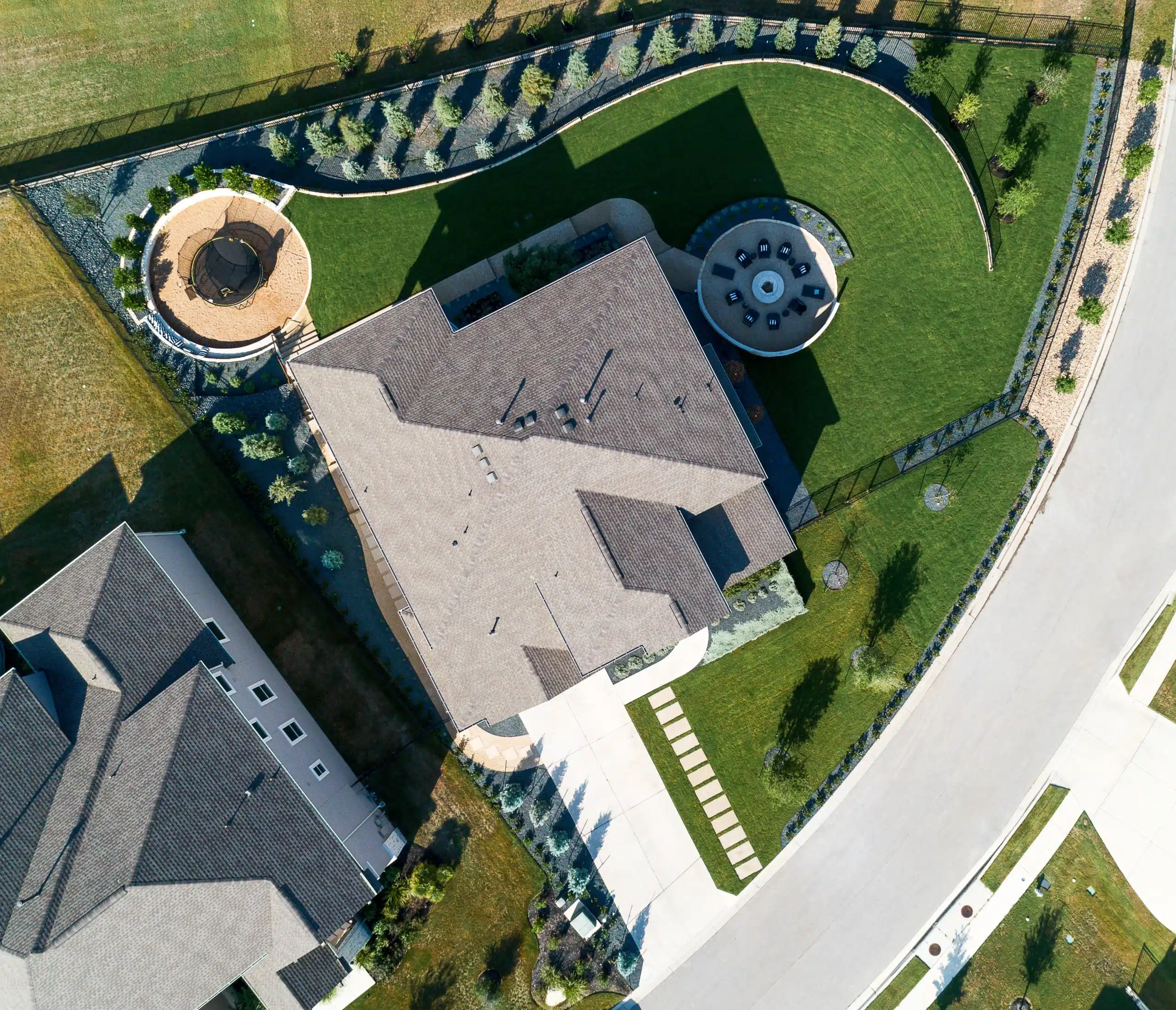 aerial view from directly above a home showcasing front and backyard landscape design flow