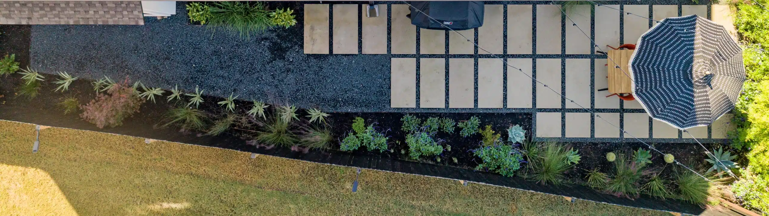 aerial view of large pavers making patio extension with outdoor table and chairs