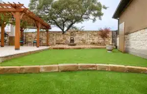 tiered landscape design with stone retaining wall and outdoor decor in Georgetown, Texas