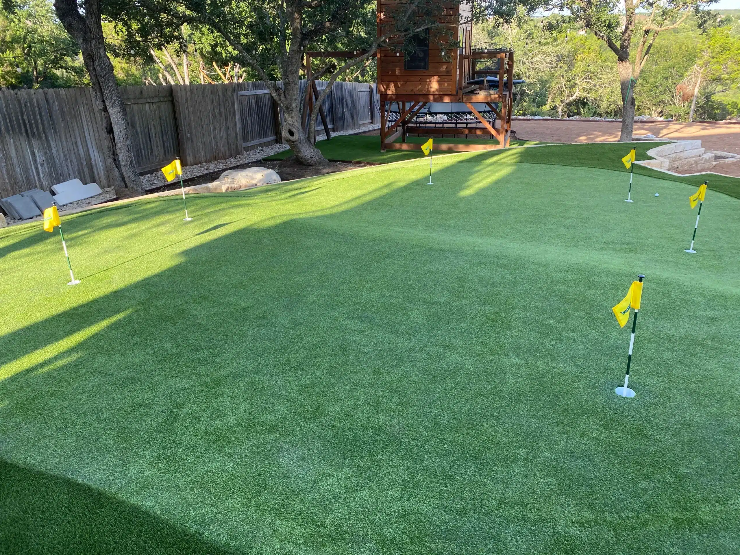 mini golf and turf in backyard of central texas home